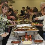 EDMONTON,AB; March 28 2010: A crowd gathers to sample the food from serving tays on a table in the basement of the Laurier heights baptist church located at 8505 142 street in Edmonton, Alberta on Sunday March 28 2010. This is for an Easter brunch story on pastor Steve's congregation as they made a brunch to celebrate Palm and Easter  Sunday. But it's also part of their church tradition - to create food for each other as a sign of love and to celebrate Easter. Pastor Steve is an ardent foodie and home chef and does all the cooking for his family and considers this a real gesture of love towards his wife, so this story is all about communities and cooking and love and Easter and rebirth.    (Walter Tychnowicz /Edmonton Journal )